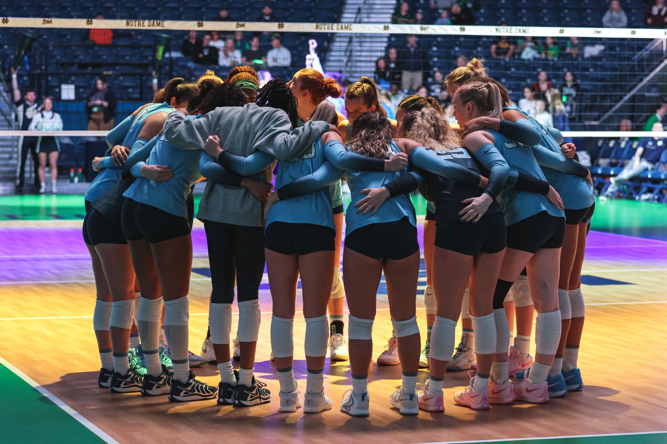 Carolina Volleyball team groupd huddle during game
